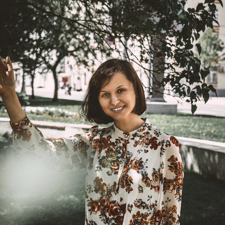 Mira Shah, Lead Design Curator at Hushed Canyon Steady, reviewing corporate floral arrangements